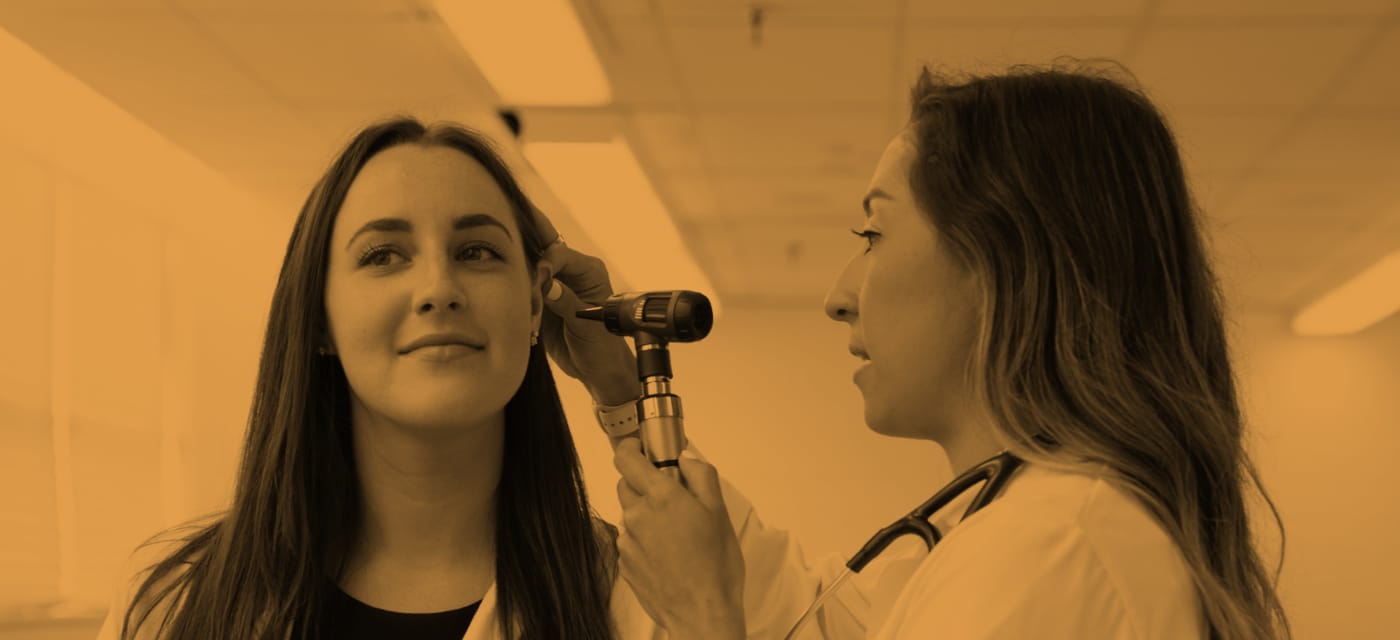 PA student examining a patients ear