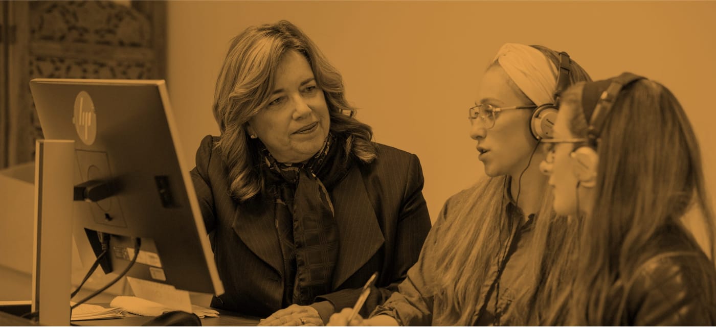 Speech instructor with two students wearing headphones